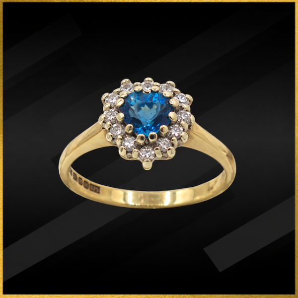 9 carat yellow gold blue topaz and cubic diamond ring